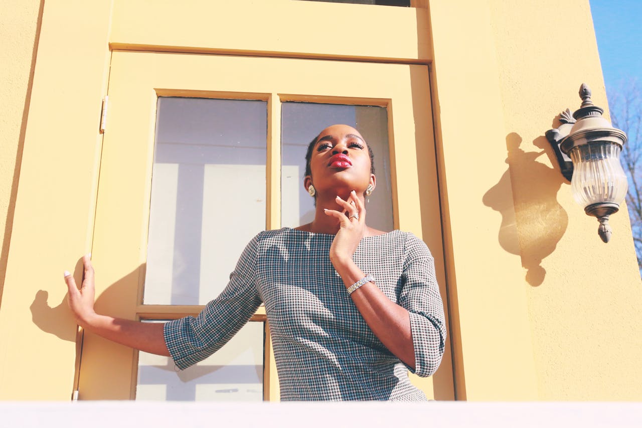 services-01 A fashionable woman posing confidently in her stylish dress against a sunny backdrop.